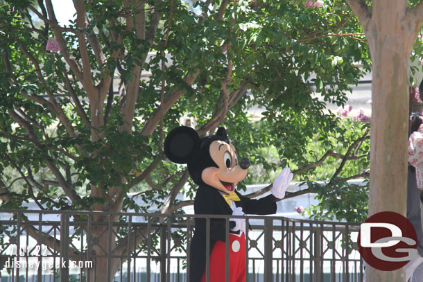 Mickey Mouse greeting guests in the small world mall area.  There was a line to wrapping up so you could see him clearly when I passed by.