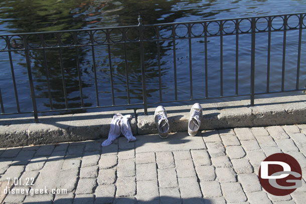 Thought this was funny.  At first glance I thought people were saving spots for Fantasmic then I realized they were trying to dry out their shoes and socks.