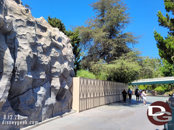 Walls stretch around the front of the mountain blocking the queue area.