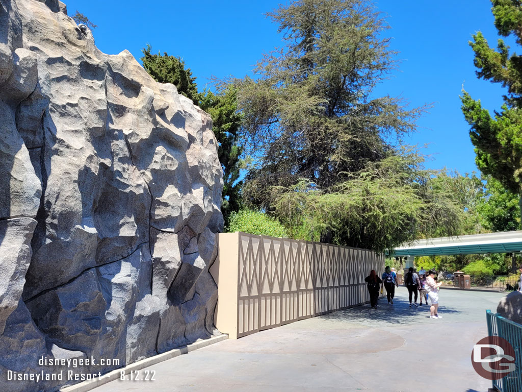 Walls stretch around the front of the mountain blocking the queue area.