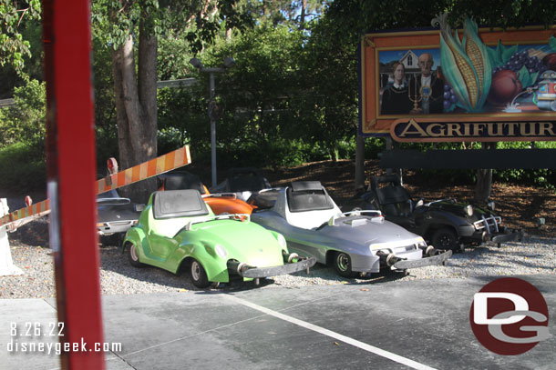 A half dozen Autopia Cars parked along the tracks backstage