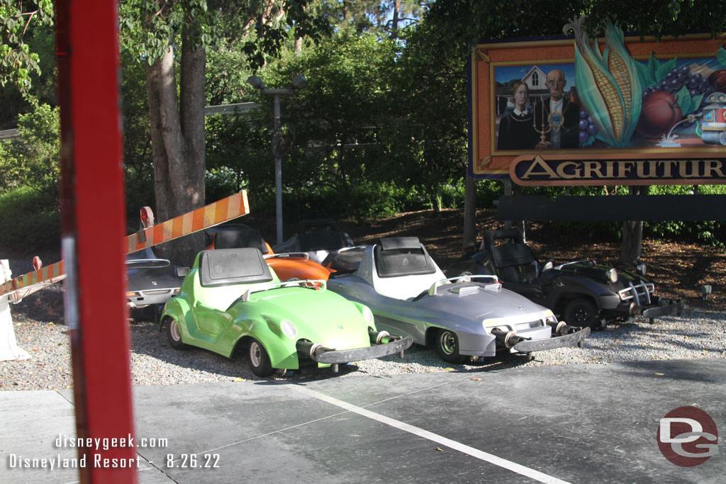 A half dozen Autopia Cars parked along the tracks backstage