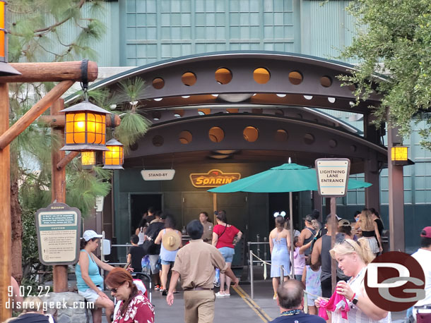 Stand by guests walking in, while Lightning Lane are delayed due to questions and scanning.