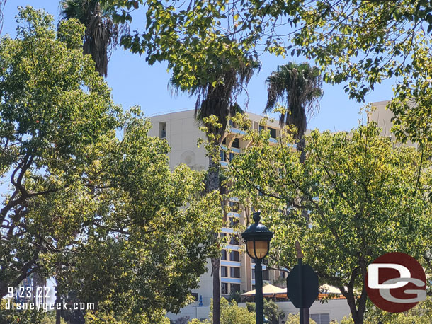 Paradise Pier Hotel through the trees.  Not a lot of visible progress from this angle.