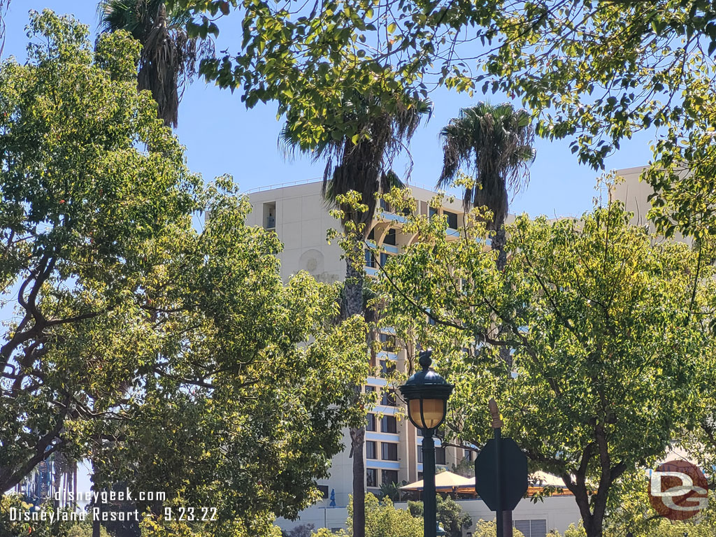 Paradise Pier Hotel through the trees.  Not a lot of visible progress from this angle.