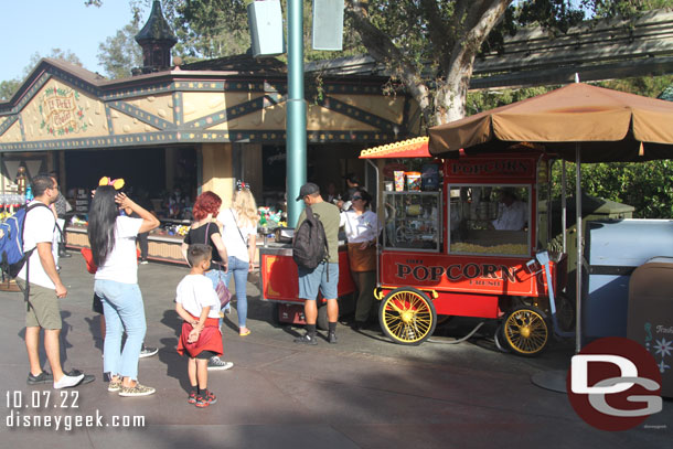 A handful of groups in line for popcorn  in Fantasyland.