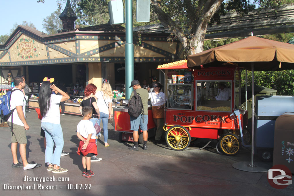 A handful of groups in line for popcorn  in Fantasyland.