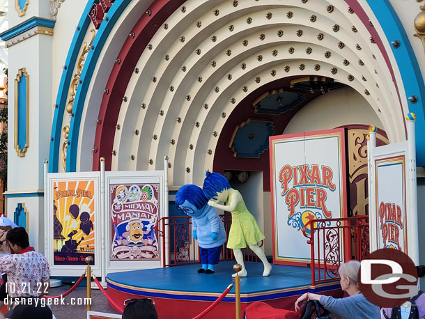 Joy and Sadness out interacting with guests on Pixar Pier.