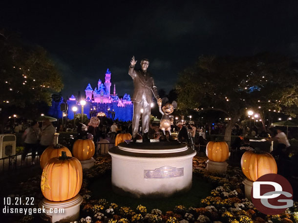 Partners and Halloween pumpkins with snowy Sleeping Beauty Castle