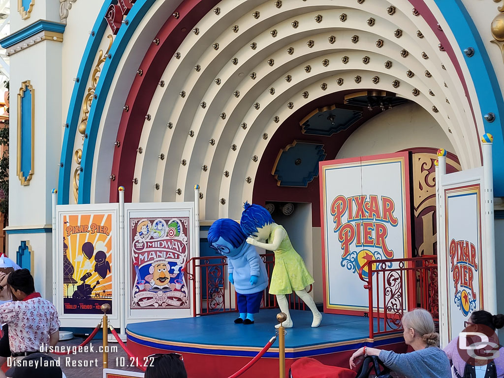 Joy and Sadness out interacting with guests on Pixar Pier.