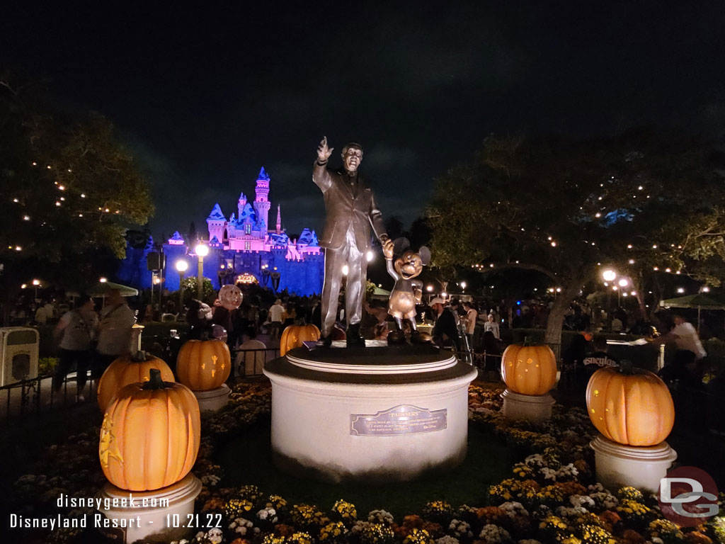 Partners and Halloween pumpkins with snowy Sleeping Beauty Castle