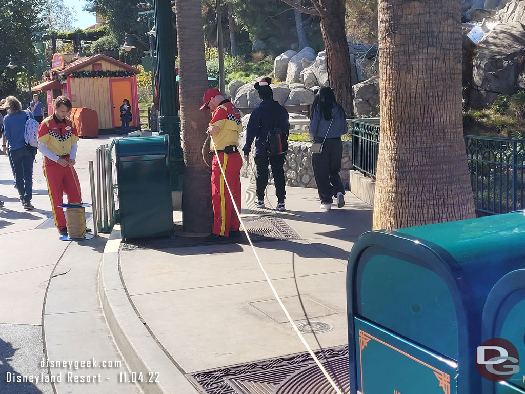 Cast Members were preparing ropes for future queue and crowd flow needs. They were cutting and labeling them.