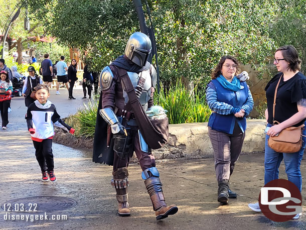 Din Djarin, the Mandalorian, and Grogu, the child, visiting Batuu today.