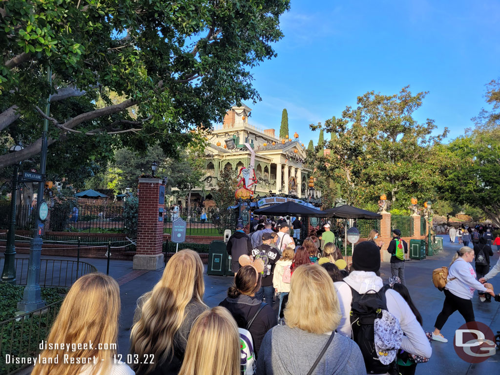 8:06am - In line for Haunted Mansion Holiday, a slight delay entering the grounds.