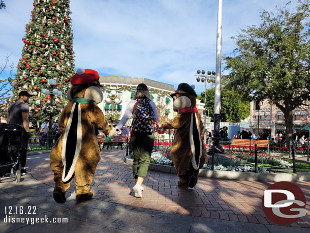 Chip N Dale leading a guest around Town Square.