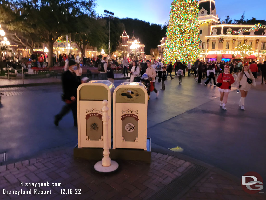 Trashcans covering where a lamp post has been removed for some work.