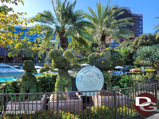 A Disney100 medallion added to the topiaries.