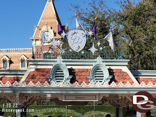 Disney100 shields above the entrances to Disneyland.