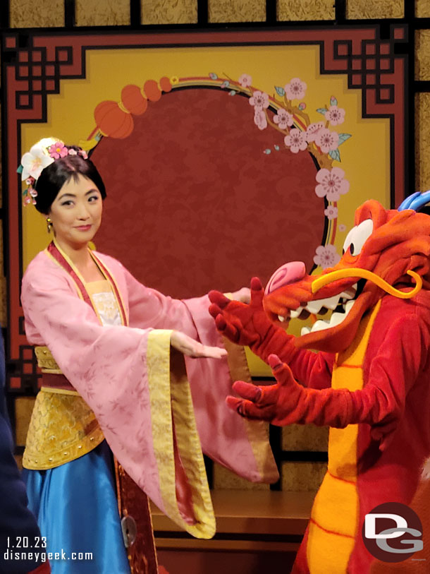 Mulan and Mushu greeting guests