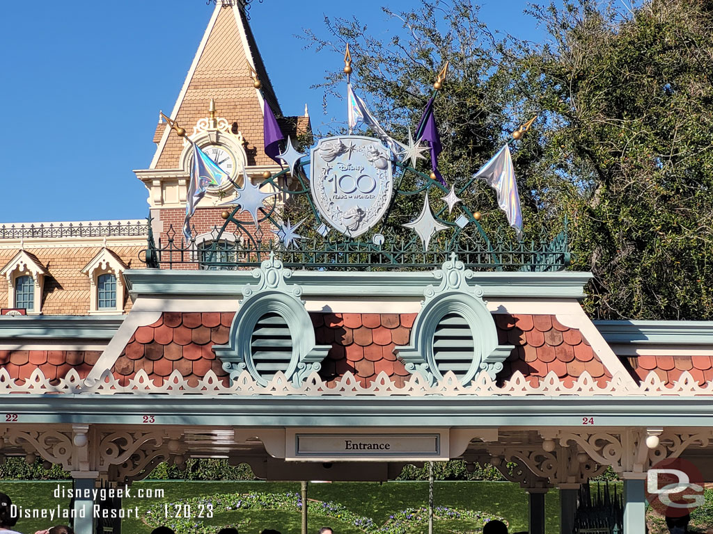 Disney100 shields above the entrances to Disneyland.