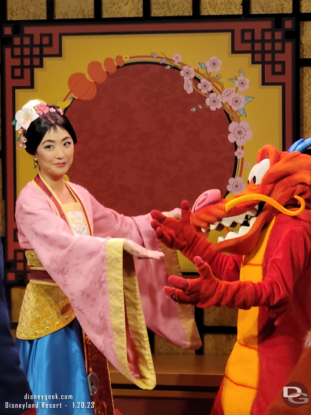 Mulan and Mushu greeting guests