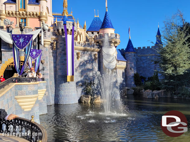 There are fountains on either side of the castle for Disney100