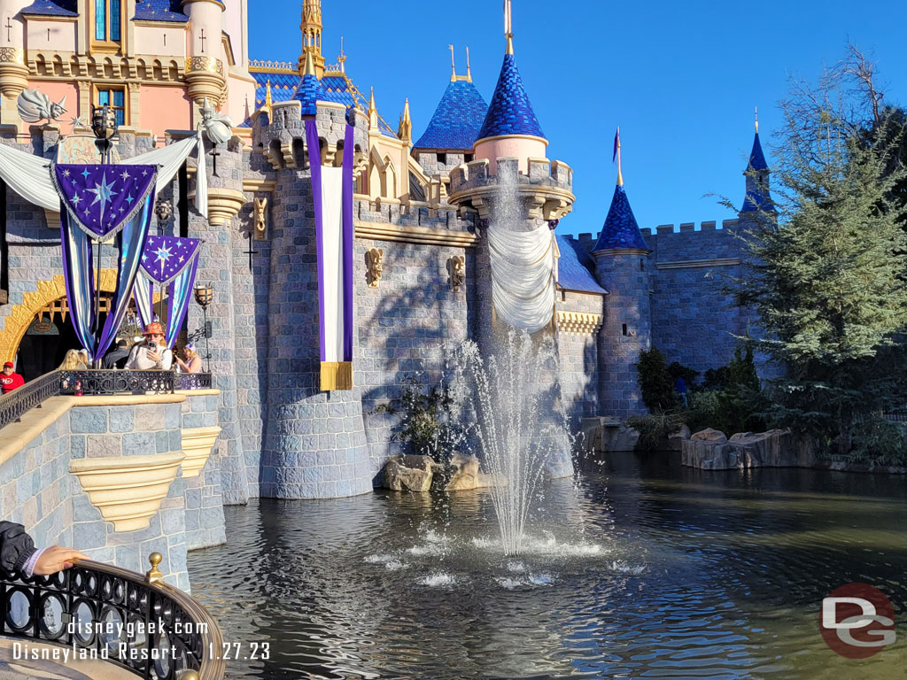 There are fountains on either side of the castle for Disney100