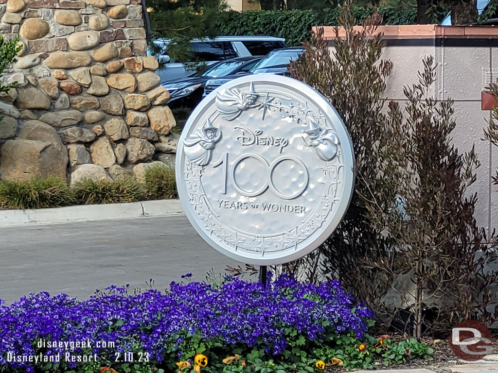 A Disney100 medallion at the hotel entrance