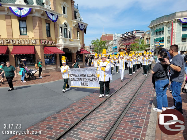 A high school band marching through Town Square