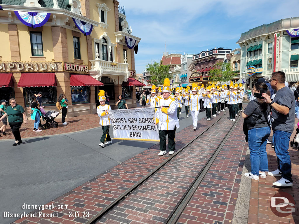 A high school band marching through Town Square