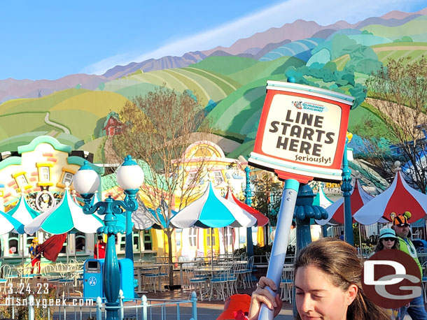 A cast member heading toward the end of the line that stretched toward Fantasyland at the moment.