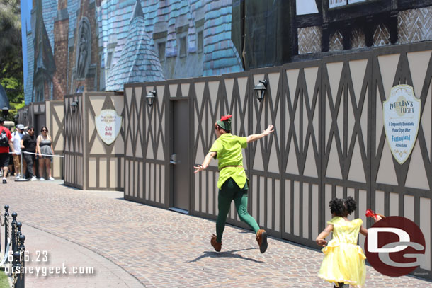 Peter Pan leading guests around Fantasyland.  His attraction is still closed.