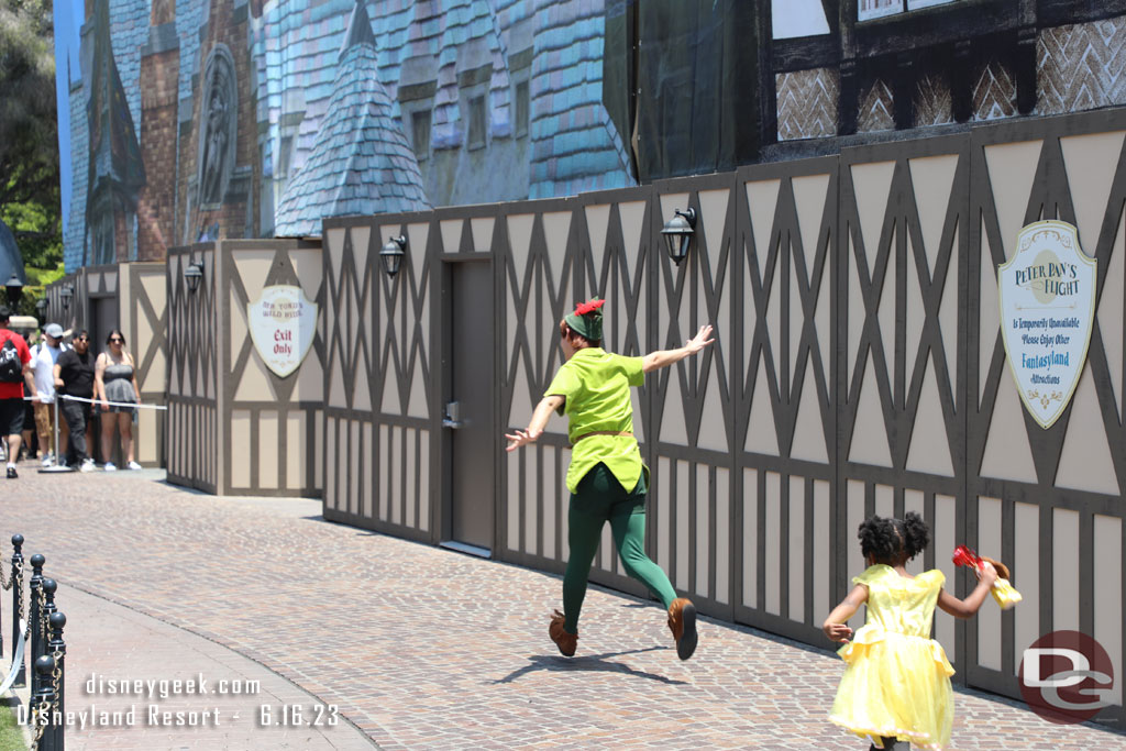 Peter Pan leading guests around Fantasyland.  His attraction is still closed.