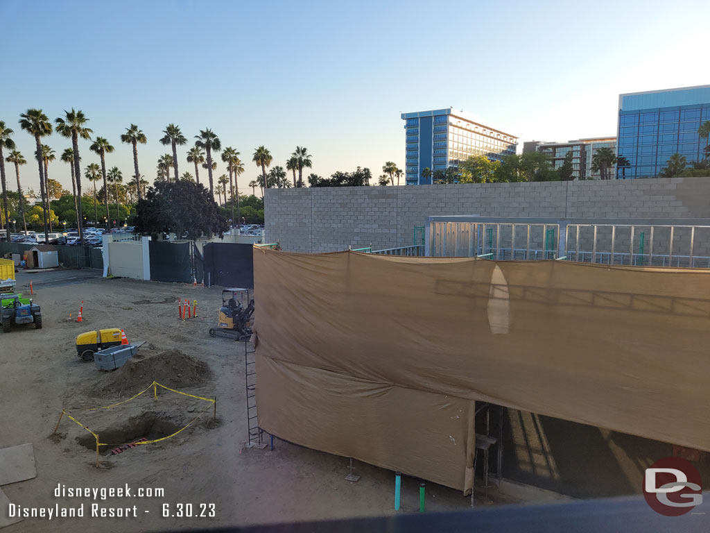 Scaffolding and scrims up as they work on the exterior of the small building closest to the Monorail