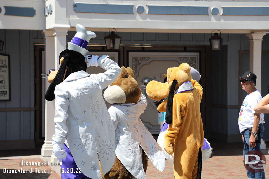 Goofy, Pluto and Chip saluting Mickey