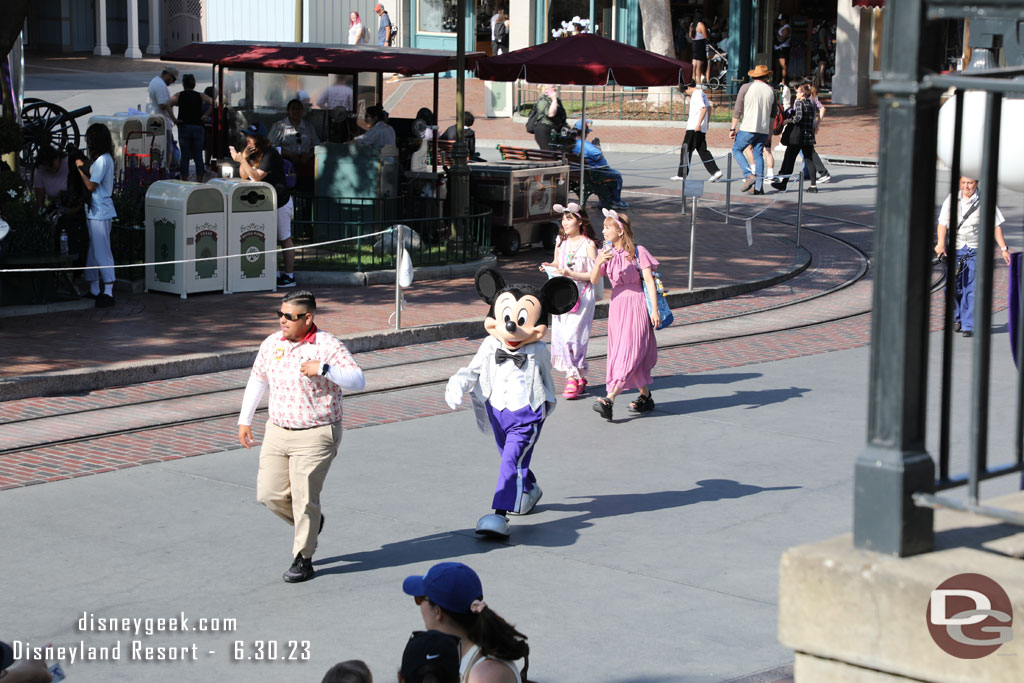 Mickey in his 100 Year outfit strolling through Town Square