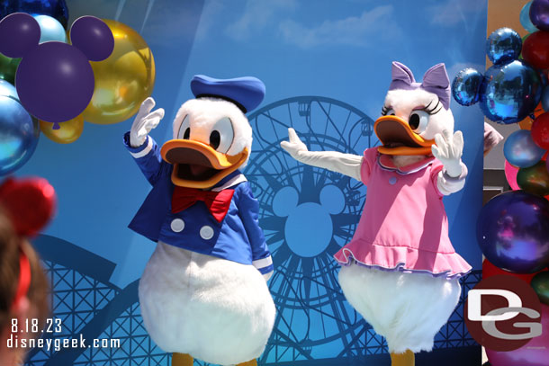 Donald Duck and Daisy Duck greeting guests at a special photo op near the restrooms