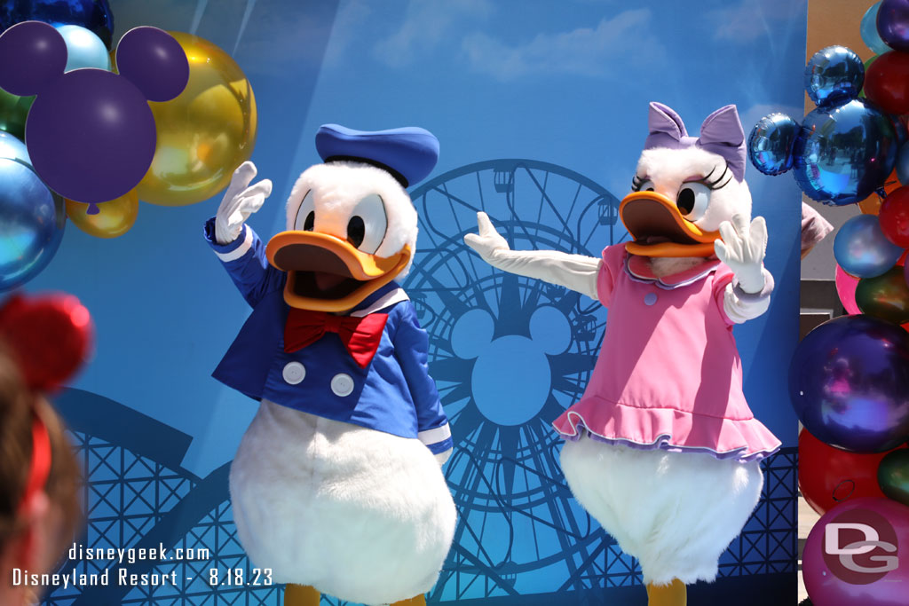 Donald Duck and Daisy Duck greeting guests at a special photo op near the restrooms