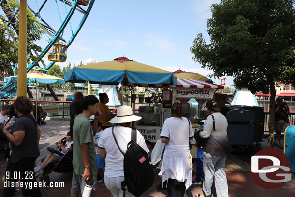 Only a few guests in line for popcorn buckets on Pixar Pier.