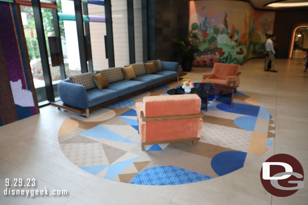 Inside the lobby is a sitting area and beyond it a mural.