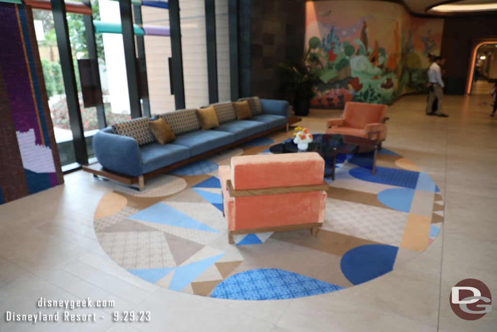 Inside the lobby is a sitting area and beyond it a mural.