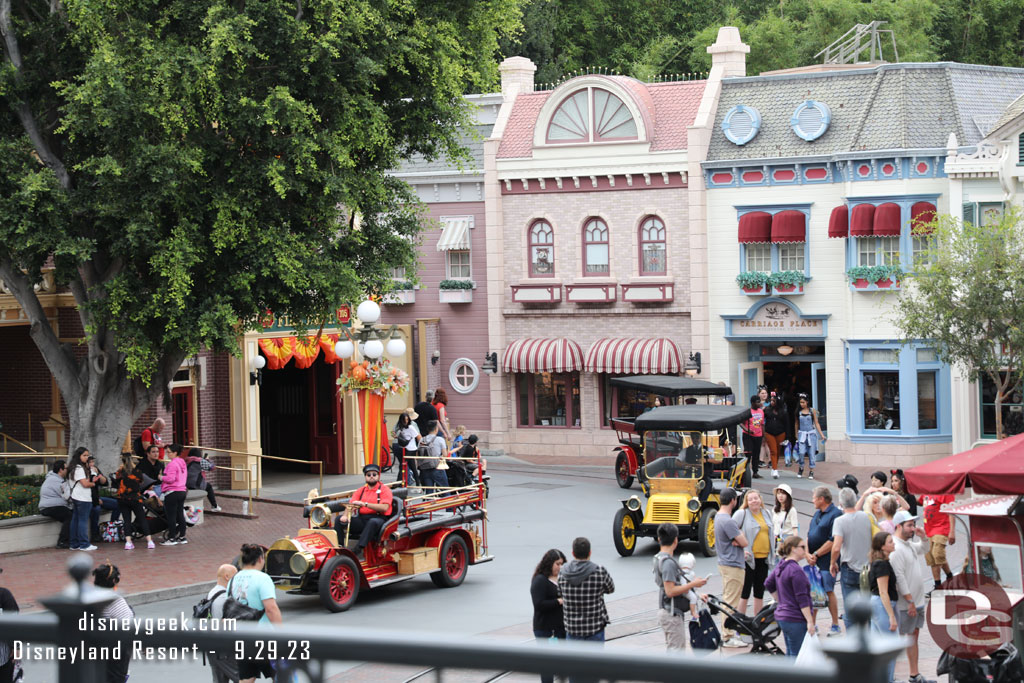 A parade of Main Street Vehicles making their way back onto the street.