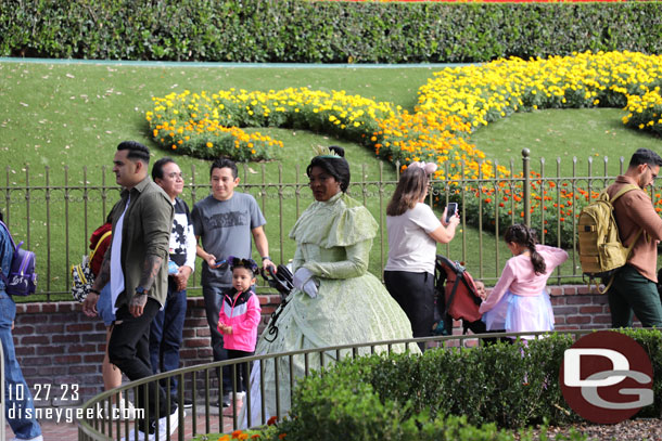 Tiana out greeting guests near the park entrance in her cold weather costume.  It was about 70.