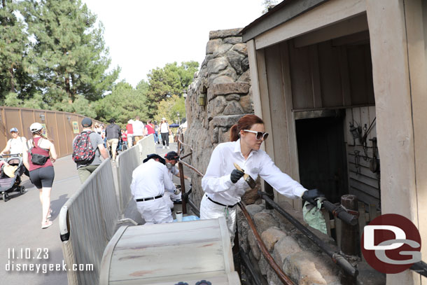 A team working on painting/restoring the railings