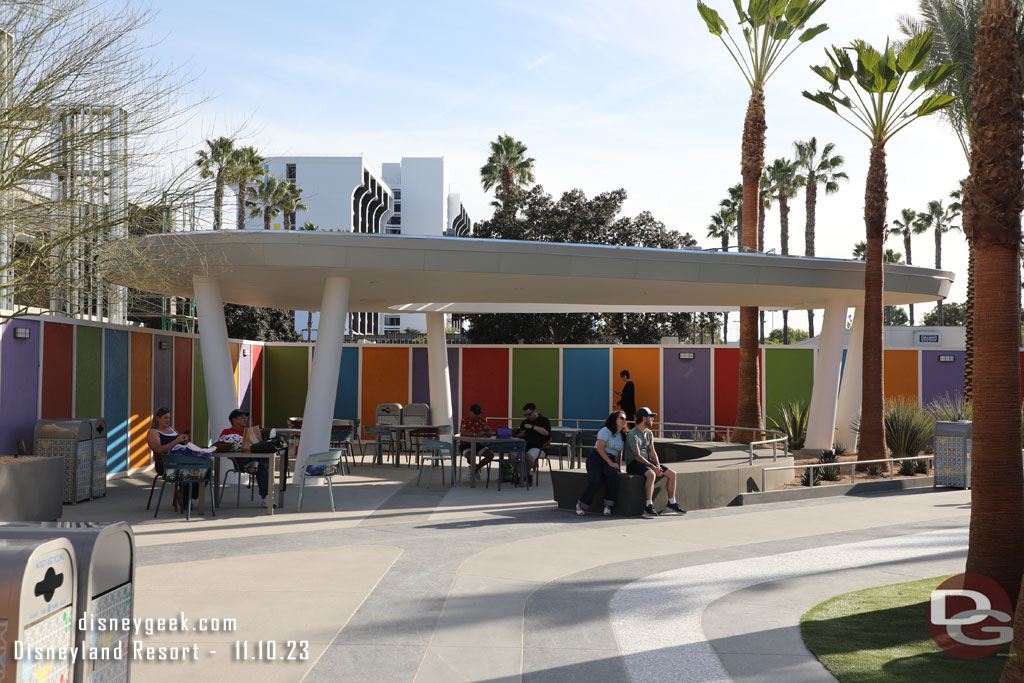 A partially covered seating area on the opposite end of the lawn