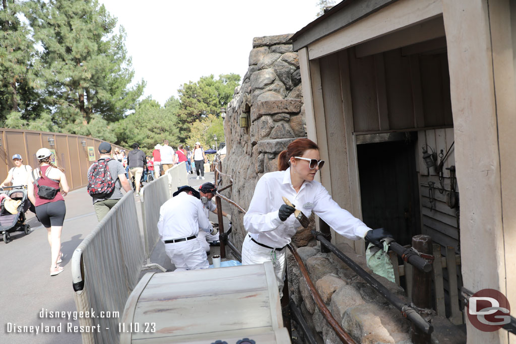 A team working on painting/restoring the railings