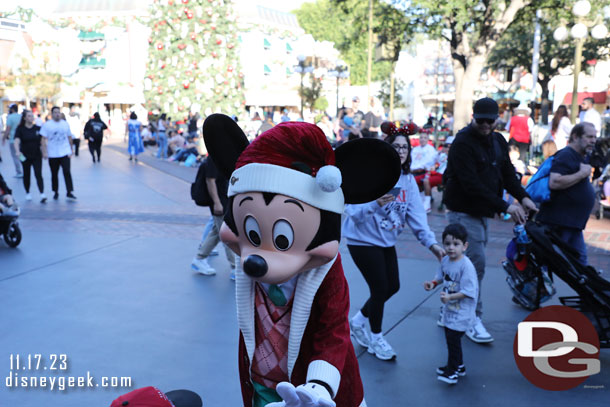 Mickey Mouse visiting guests who were waiting for the parade