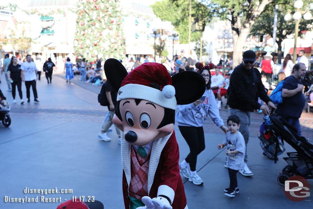 Mickey Mouse visiting guests who were waiting for the parade