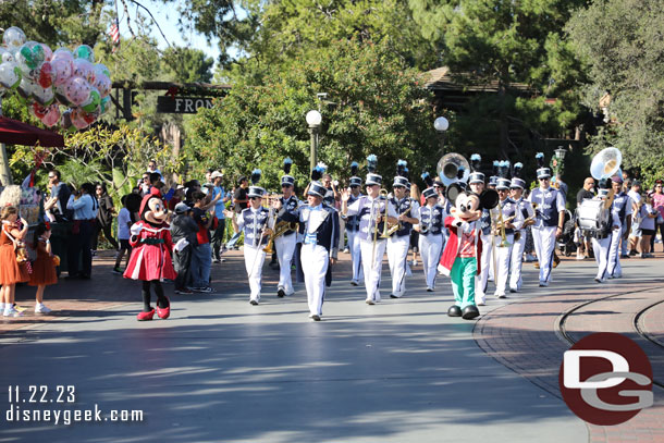 Mickey and Minnie leading the Disneyland Band in a march to Town Square