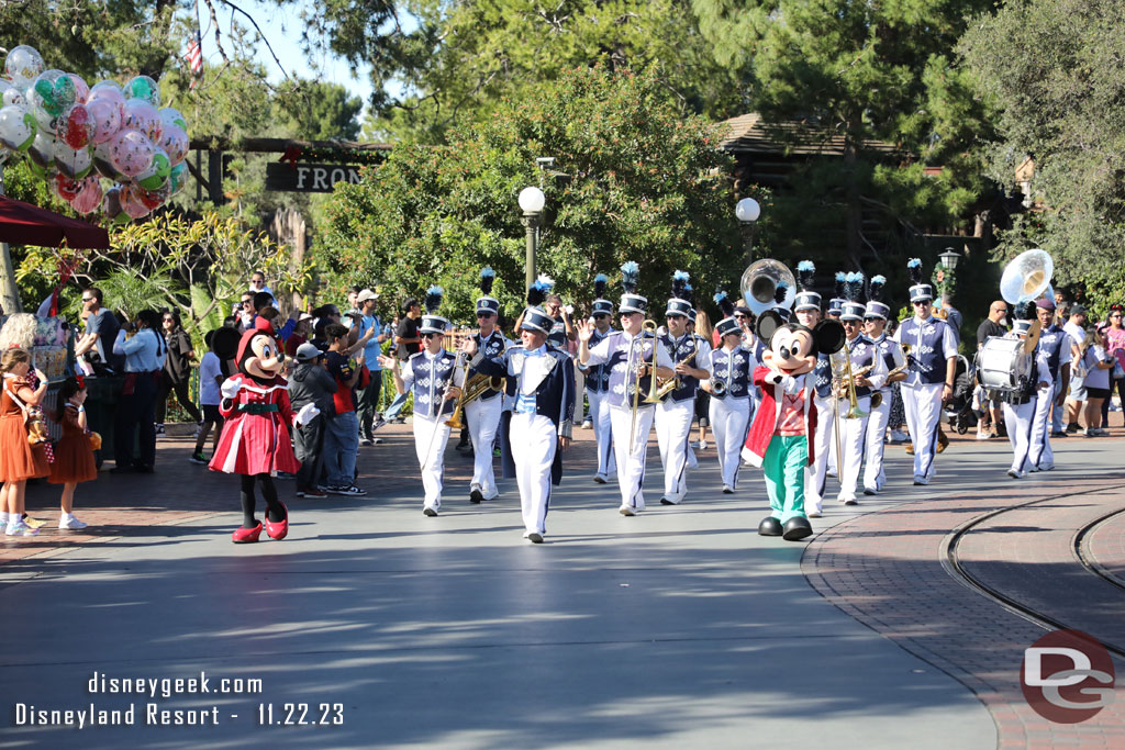 Mickey and Minnie leading the Disneyland Band in a march to Town Square